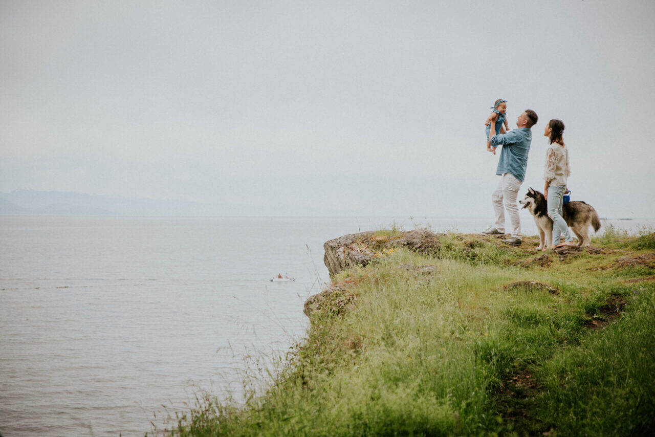 Victoria BC Family Photographer | family on cliff on Vancouver Island Beach with dog